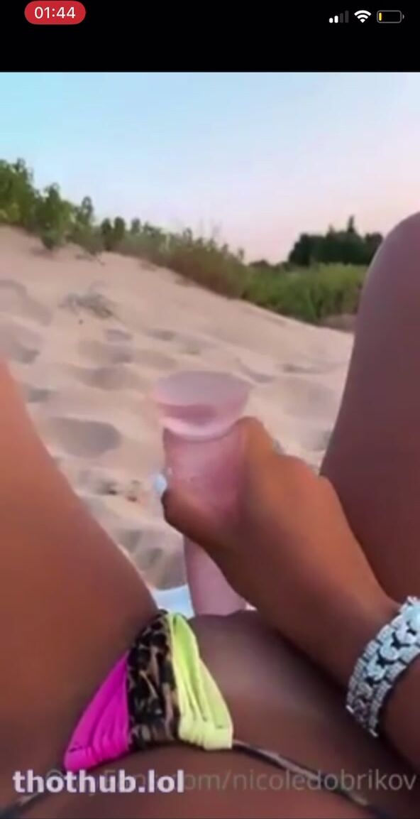Nicole Dobrikov playing with her dildo on the Beach